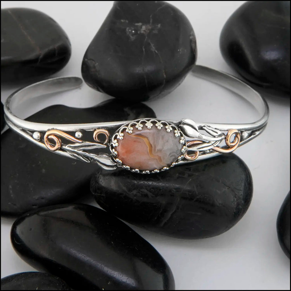 Crazy Lace Agate cuff bracelet set in a Sterling Silver Frame, with sterling silver tulips and beads, with 14K rose gold-filled swirls.