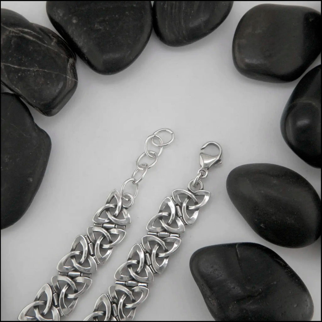 Sterling Silver Open Trinity Knot bracelets with interlinking hinge-style links. Attached by a large lobster clasp and adjustable links