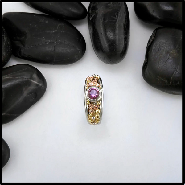 Pink Spinel ring set in tri-color gold Celtic ring