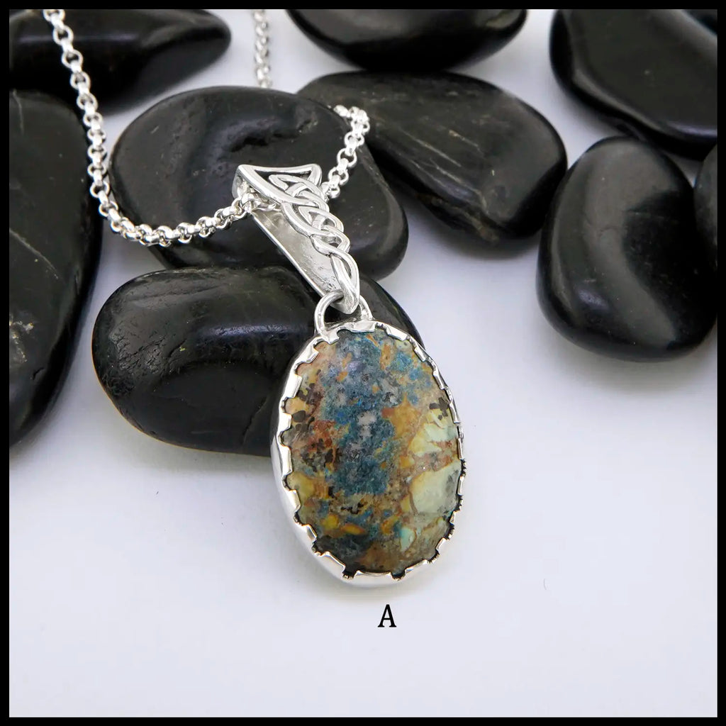 Silver necklace with a pendant featuring a natural stone on a white background