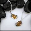 Petrified wood teardrop cabochon set in sterling silver with leaves.