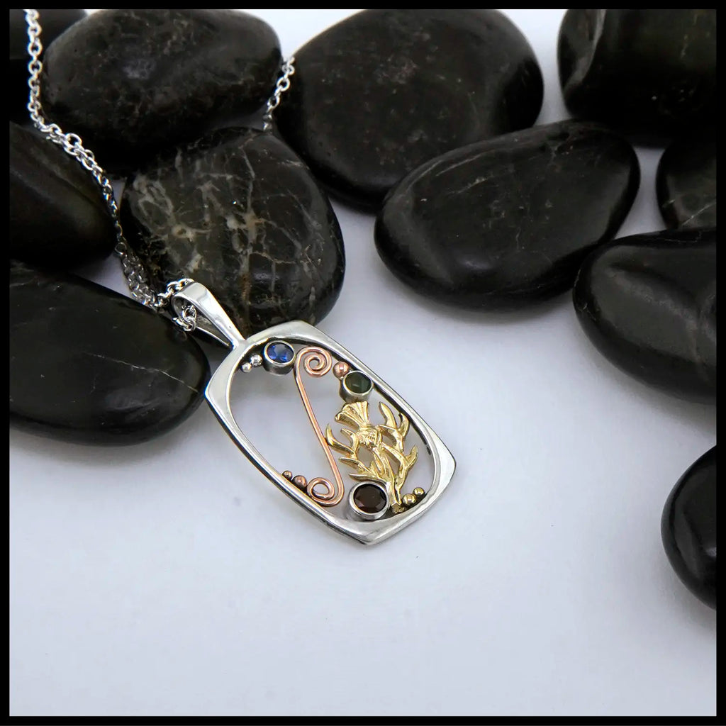 Sterling Silver Pendant with yellow gold thistle and rose gold details set with Jade, topaz, and garnet.
