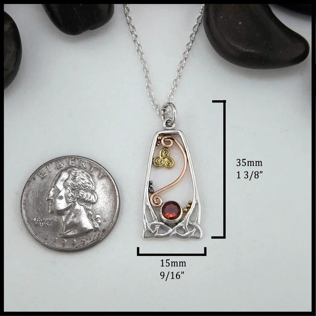Silver Celtic Pendant with Citrine and yellow and rose gold details next to quarter for scale 35mm long by 15mm wide