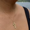 Small Celtic Trinity and Dove Cross in 14K Gold worn lakeside on a gold chain