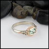 This Mint Garnet is set in a 14K Yellow and Rose Gold frame