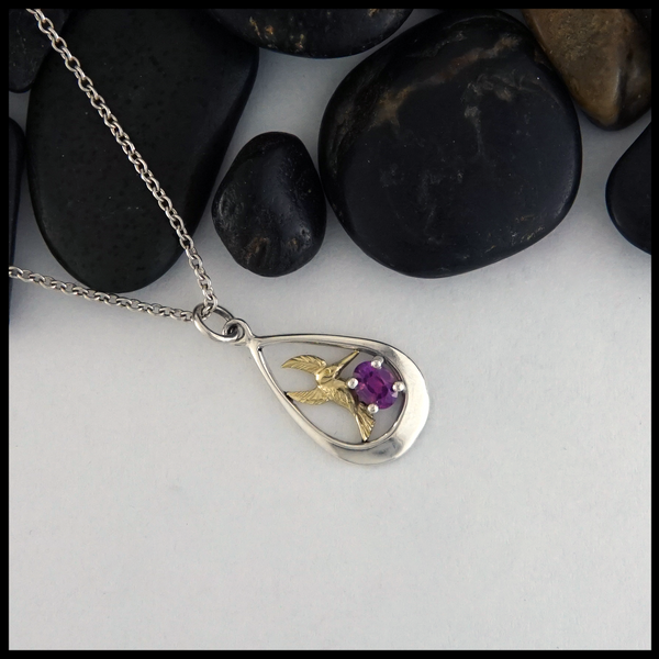 Custom Hummingbird pendant in Sterling Silver  with 18K Yellow Gold Hummingbird, set with an oval, deep pink Sapphire.