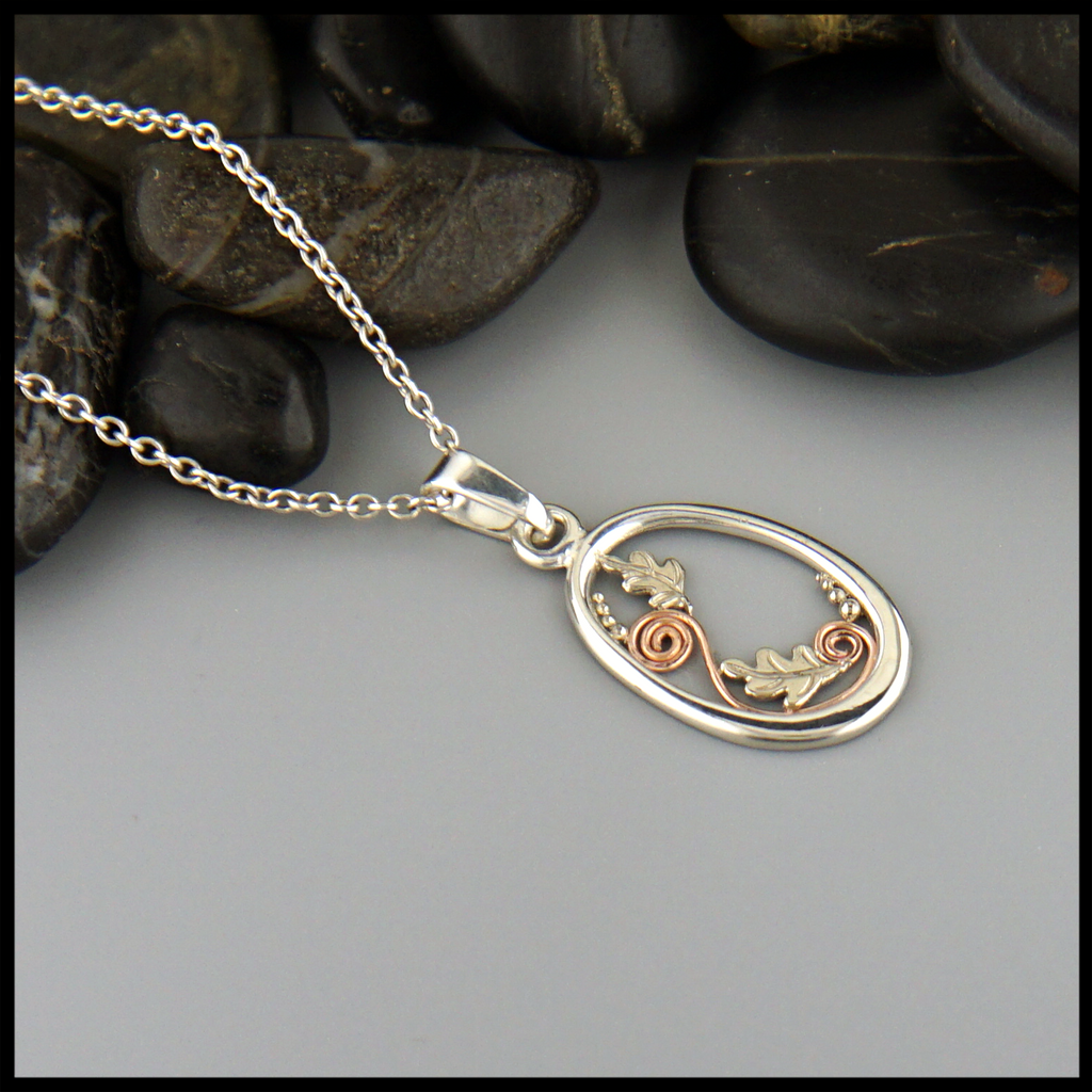 Leaf Flourish pendant in Sterling Silver with 14K Rose Gold spirals and  14K White Gold oak leaves and bead accents.