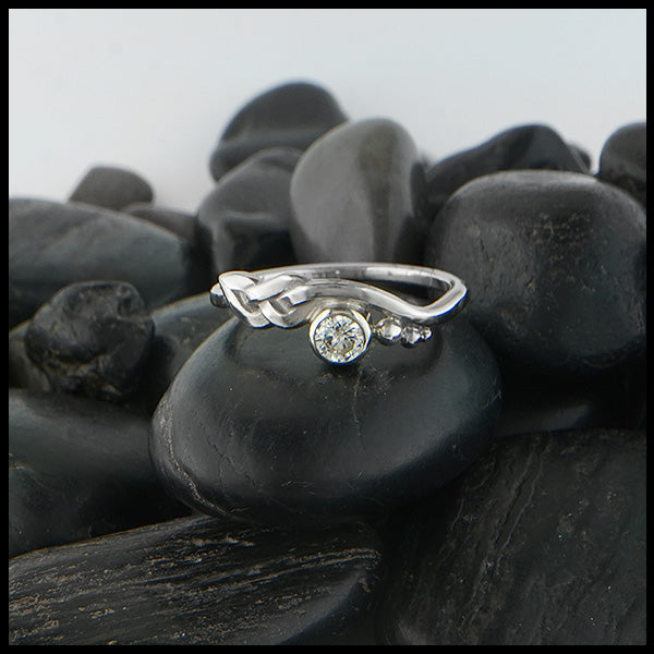 Custom whimsical knot ring in 14K White Gold with a bezel set 1/3 CT diamond. 