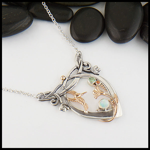 Custom Whimsical Hummingbird pendant in Sterling Silver, with 14K Rose Gold hummingbird, flower, and accent beads, set with an Opal, Mint Garnet and a dainty Rhodolite Garnet.