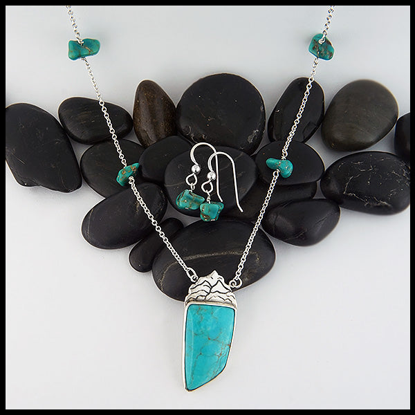 Custom Mountain Turquoise pendant in Sterling Silver, set with a large Turquoise stone. This pendant comes on a 16" cable chain and is set with 4 smaller Turquoise stones along the chain. Set shown with matching turquoise earrings.