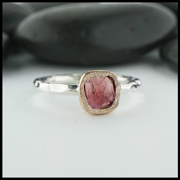 Custom, rustic, hand fabricated ring in sterling silver with a textured rose gold bezel, set with a Rose Cut Magenta Tourmaline.