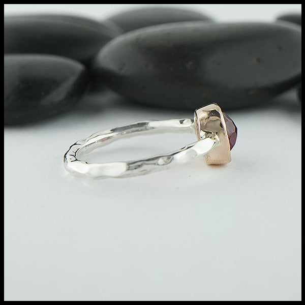 Profile view of custom ring in sterling silver with a textured rose gold bezel, set with a Rose Cut Magenta Tourmaline.