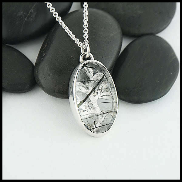 Custom hand-fabricated pendant in Sterling Silver with one of a kind Rutilated Quartz and hand-pierced vine design with 18K yellow gold details on the back.  Design is visible through the stone.