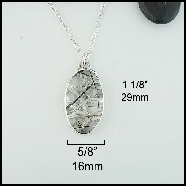 Rutilated Quartz pendant measures 1 1/8" by 5/8". 