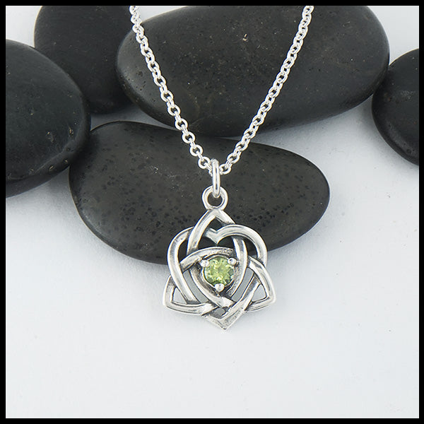 Limited Edition Trinity Knot Heart Pendant set with a 4mm Peridot. Shown on an 18" sterling silver cable chain.
