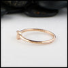 Profile view of simple 14K Rose Gold ring bezel set with a 0.09ct Emerald Cut Diamond.