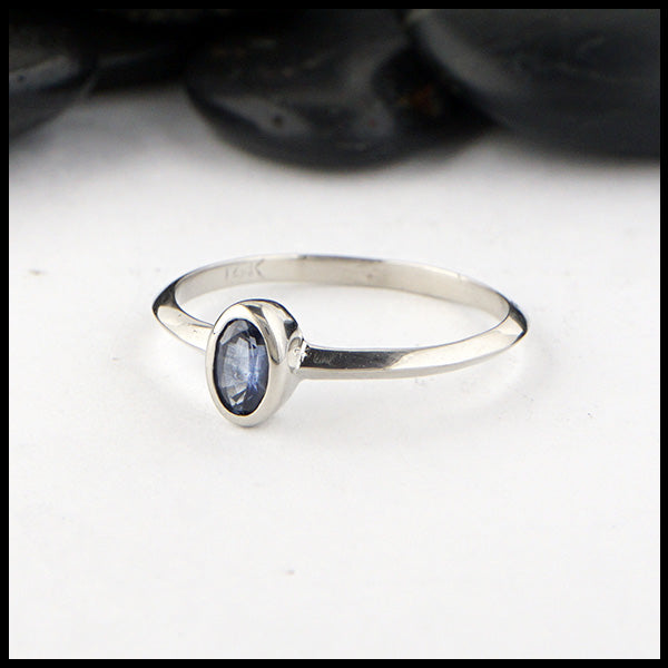 Simple 14K White Gold ring bezel set with a 0.36ct Oval Ceylon Blue Sapphire. 
