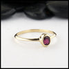 Simple 14K Yellow Gold ring bezel set with a 0.47ct 5x4mm oval Ruby.