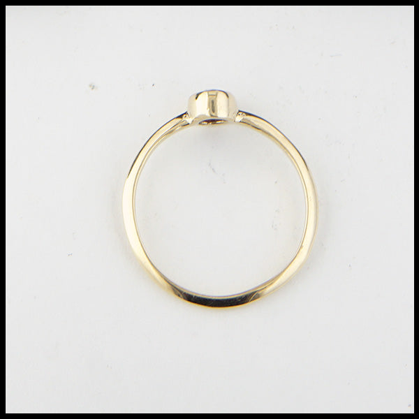 Profile view of simple 14K Yellow Gold ring bezel set with a 0.47ct 5x4mm oval Ruby.