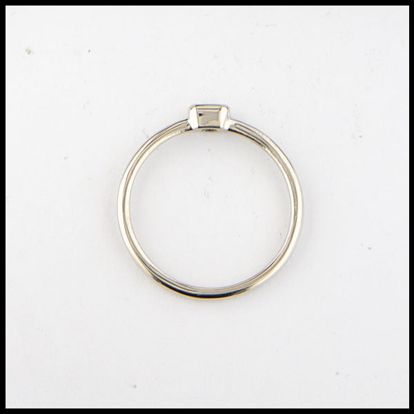 Profile view of simple 14K White Gold ring bezel set with a 0.09ct Emerald Cut Diamond.