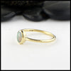 Simple 18K Yellow Gold ring bezel set with a 0.36ct oval opal.