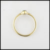 Profile view of simple 18K Yellow Gold ring bezel set with a 0.36ct oval opal.