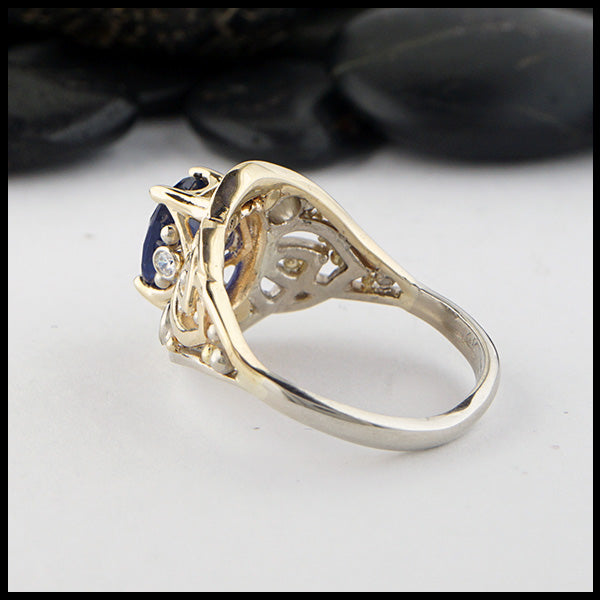 Reverse view of custom ring in 14K Yellow and White Gold. Set with a center 9x7 2.40ct blue sapphire, two 3mm and two 1.5mm diamond accents.