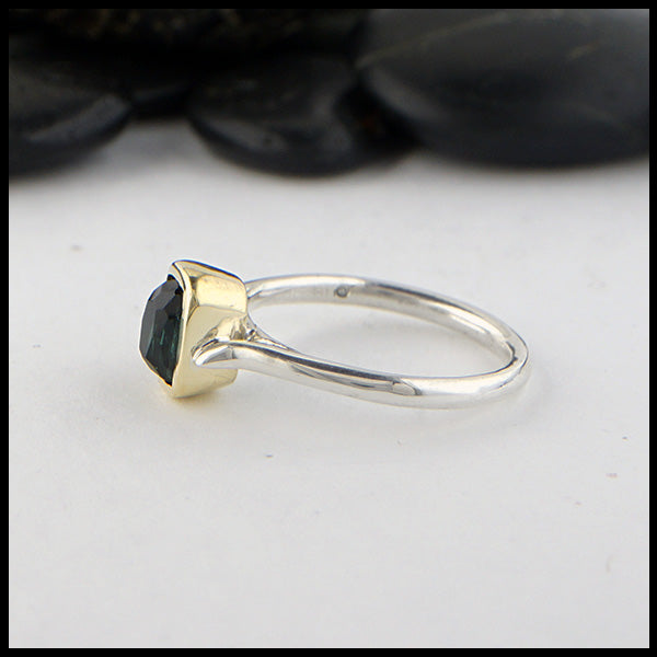 Profile view of rustic, hand fabricated ring in sterling silver with an 18K yellow gold bezel set with a Rose Cut Blue Green Tourmaline.