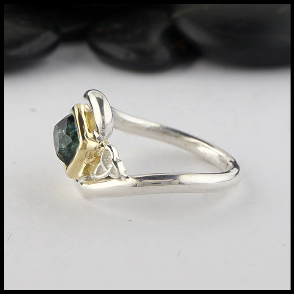Side view of rustic hand fabricated ring in sterling silver with an 18K yellow gold bezel, set with a Rose Cut  Green Tourmaline with trinity knot accents.