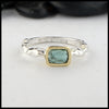 Rustic hand fabricated ring in sterling silver with an 18K yellow gold bezel, set with a Rose Cut Mint Green Tourmaline.