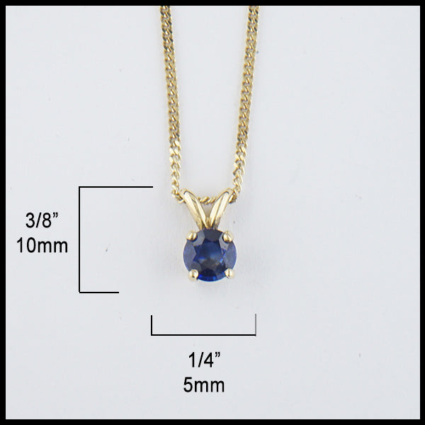 5mm Ceylon Blue Sapphire set in a 14K yellow gold setting with an 18" 14K Yellow Gold light curb chain. Measurements are 1/4" by 3/8".