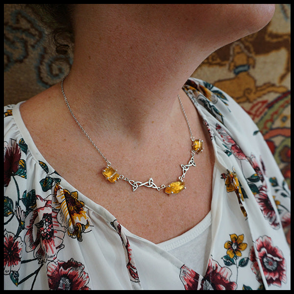 Custom Celtic Pendant with 3 links set with freeform cabochon Citrine and two trinity knot links.  Shown on model.