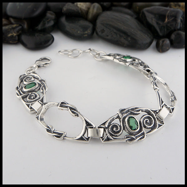 Celtic Spiral Link bracelet in Sterling Silver with Green Topaz. Made with three gemstone links & two open links.