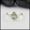 Sterling Silver and 18K yellow gold ring set with a Rose Cut Mint Green Tourmaline with trinity knot accents.