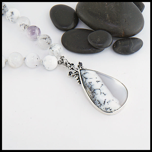 Custom beaded dendritic opal necklace with larger dendritic opal in the center and two black sapphires on either side. 