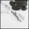 Custom beaded dendritic opal necklace with larger dendritic opal in the center and two black sapphires on either side. 