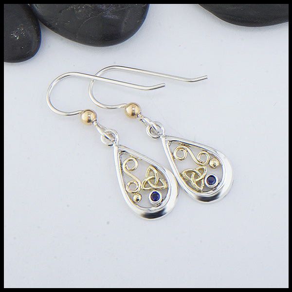 Custom Sterling Silver tear drop earrings with 18K Yellow Gold trinity knots and accents, set with a 2mm Sapphire. 