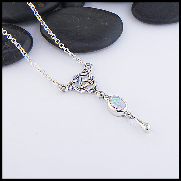 Profile view of custom Opal Dew Drop necklace featuring an opal set in Sterling Silver connected to a Triskele. Shown on an attached 18" cable chain.