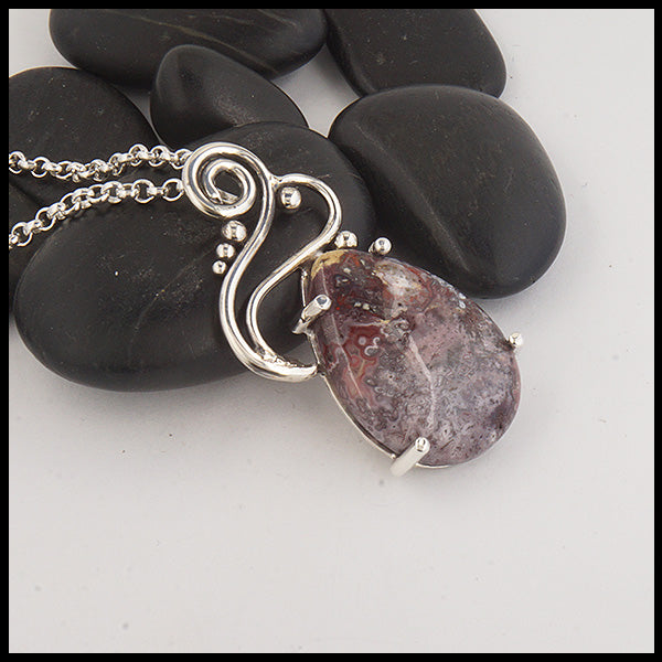 Custom Crazy Lace Agate pendant with a hand fabricated sterling silver setting.
