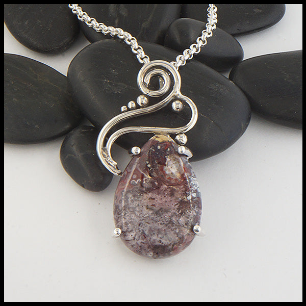 Custom Crazy Lace Agate pendant with a hand fabricated sterling silver setting.