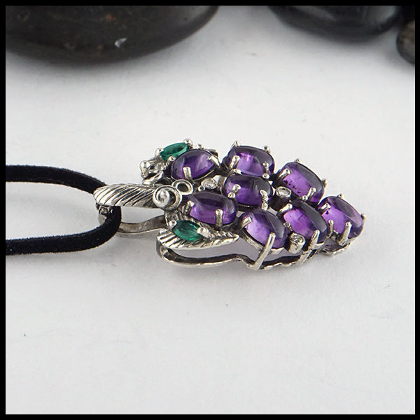 Grape Pendant  in Sterling Silver. Set with Amethyst cabochons, marquise Emeralds, and Diamond Accents.