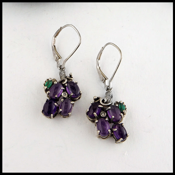 Grape Earrings in Sterling Silver. Set with Amethyst cabochons, marquise Emeralds, and Diamond Accents.