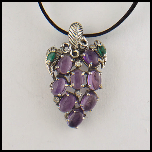 Grape Pendant in Sterling Silver. Set with Amethyst cabochons, marquise Emeralds, and Diamond Accents.