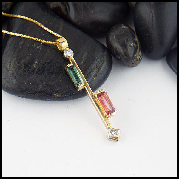 Custom pendant in 14K Yellow Gold set with a 0.46ct pink tourmaline, and a  0.34ct green tourmaline, with 0.10ct total weight of accent diamonds.