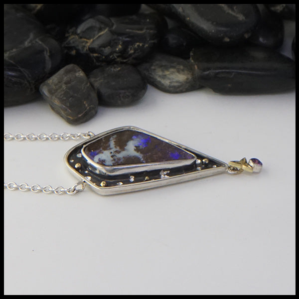 Profile view of opal and purple sapphire pendant