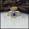 Custom Celtic Starlight ring has a 14K White Gold frame set with a 5.0mm Ceylon Sapphire, four 2mm Tsavorite Garnets, and two 1.5mm Diamonds.