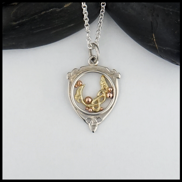 Custom celtic flourish pendant in silver and gold
