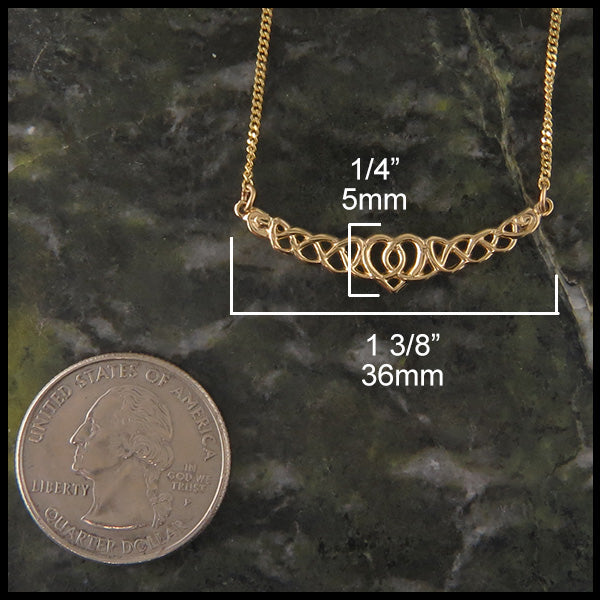 Gold heart pendant measures 1/4" by 1 3/8"