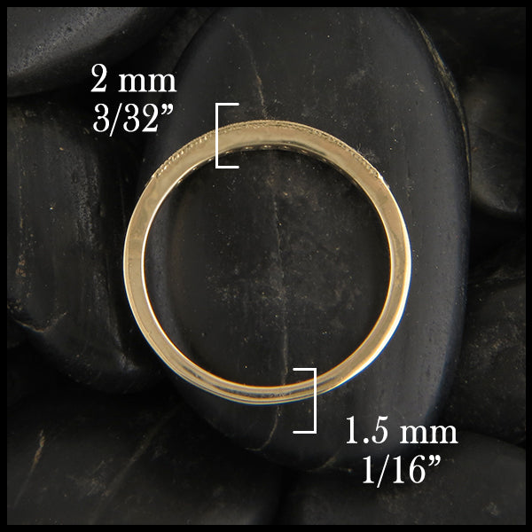 Through the finger view of 14k yellow gold milgrain stacking ring with diamonds.  2 millimeters thick at the top tapers to 1 1/2 millimeters thick at the bottom