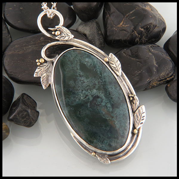 one of a kind bezel set moss agate pendant set in sterling silver with 18k yellow gold accents